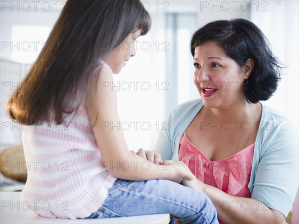 Hispanic mother comforting daughter