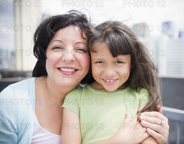 Hispanic mother and daughter hugging