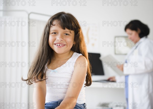 Hispanic girl sitting in doctor's office