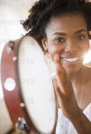 Black woman holding tambourine