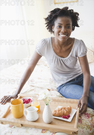 Black woman having breakfast in bed