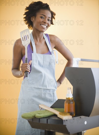 Black woman grilling on barbecue