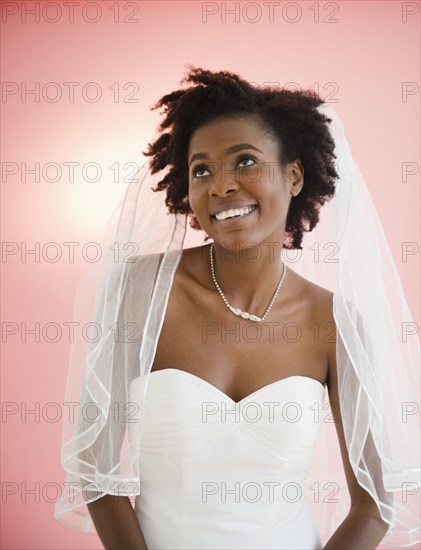 Smiling Black bride in wedding dress