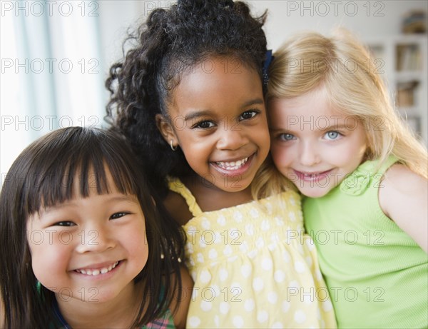 Smiling girls hugging each other