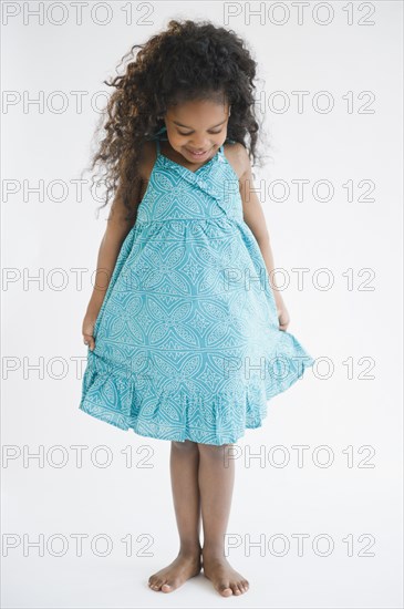 Mixed race girl admiring her dress