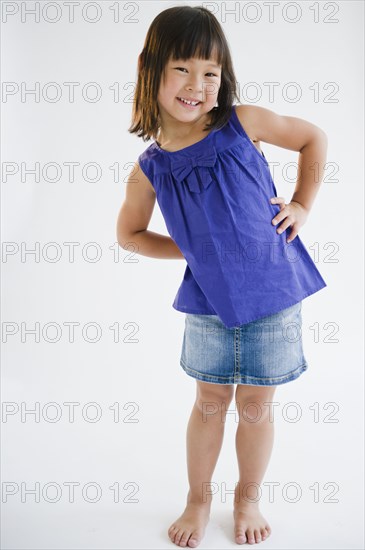 Smiling Korean girl with hands on hips