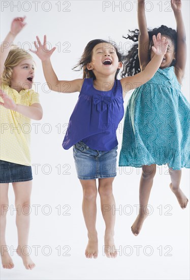 Excited girls jumping together