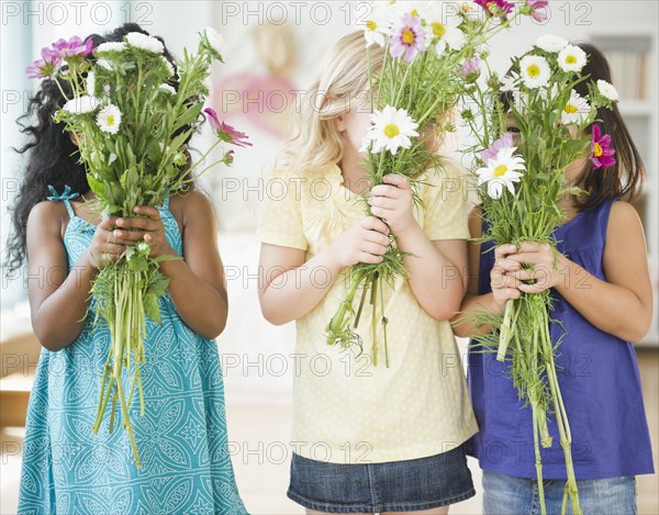 Girls holding bouquets of flowers