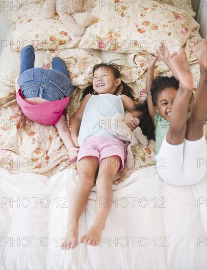 Girls playing on bed together