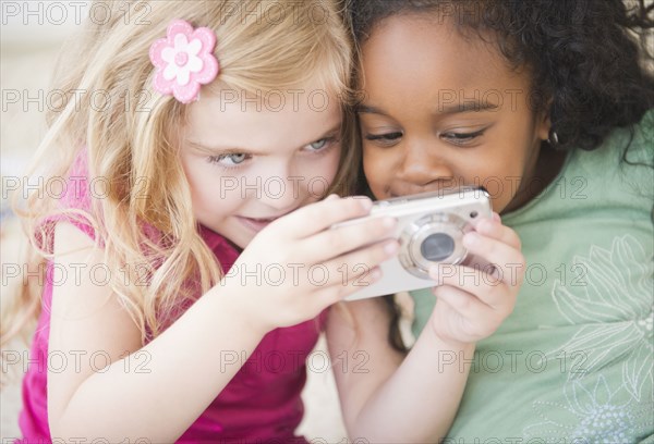 Girls looking at digital camera together