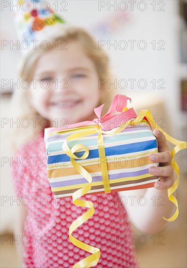 Caucasian girl holding birthday gift