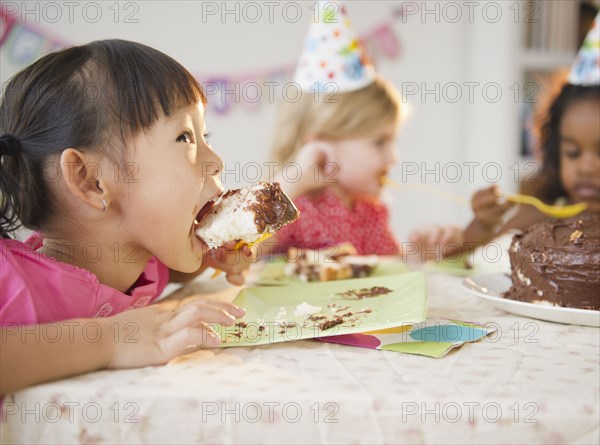 Girls enjoying cake at birthday party