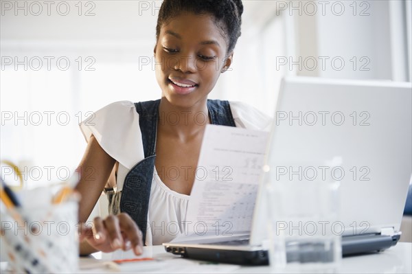 Black woman paying bills online