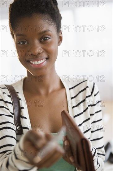 Black woman holding out credit card