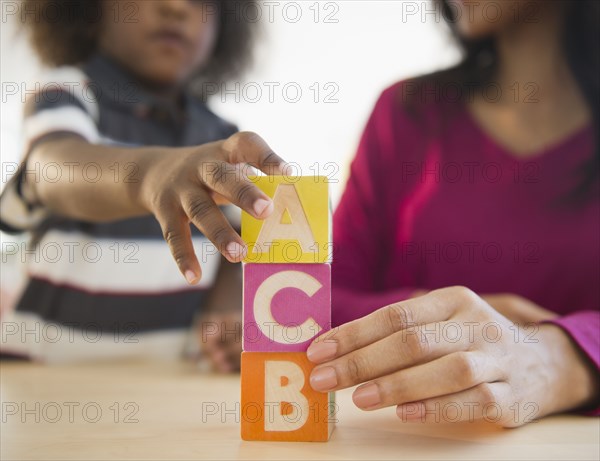 African American mother and son playing with blocks