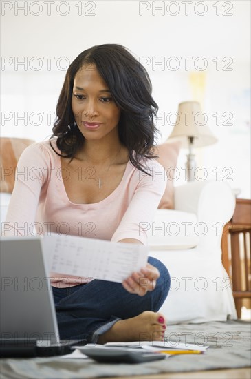 African American woman paying bills online