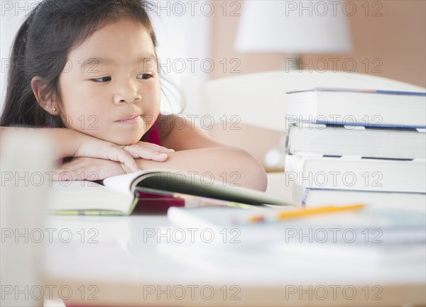 Bored Korean girl doing homework