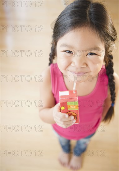 Korean girl drinking juice box