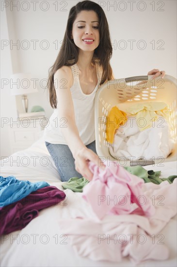 Mixed race woman doing laundry