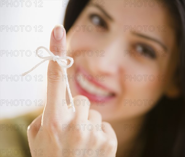 Mixed race woman with bow on her finger