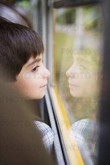 Caucasian boy riding school bus