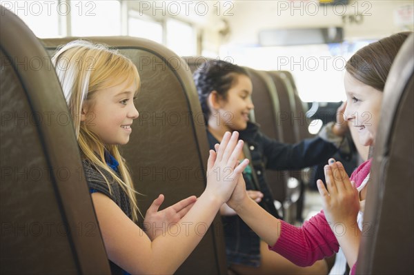 Children playing while riding school bus