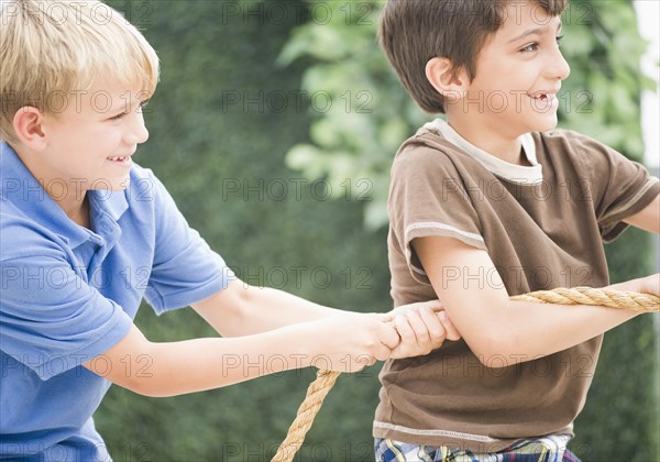 Boys pulling rope together