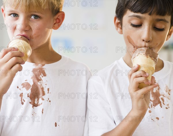 Boys eating dripping ice cream cones