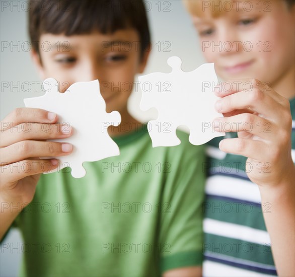 Boys putting jigsaw puzzle together