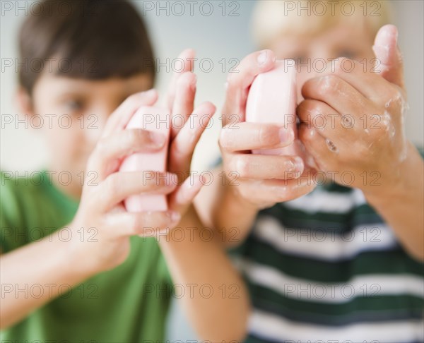 Boys washing their hands with soap