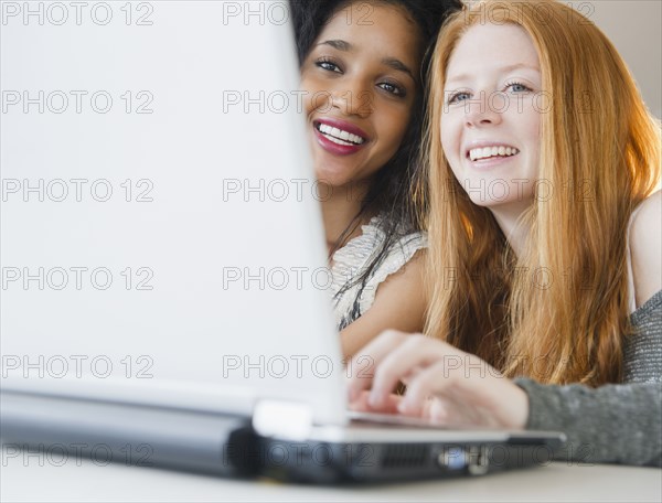 Friends using laptop together