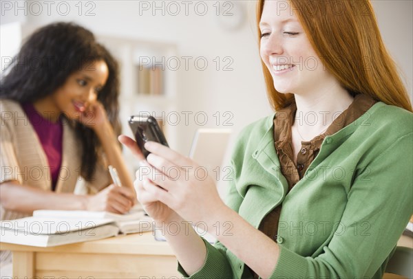 Caucasian woman text messaging on cell phone