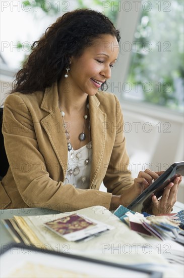 Hispanic businesswoman using digital tablet