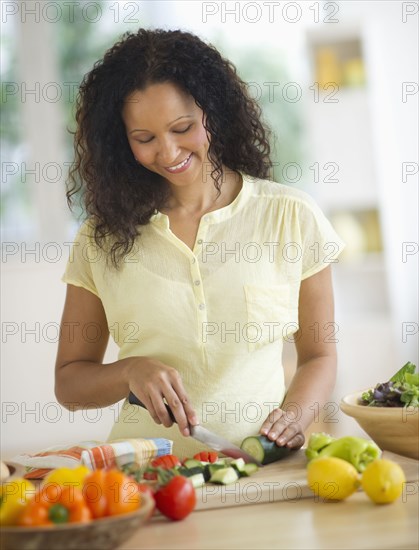 Hispanic woman chopping vegetables