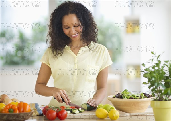 Hispanic woman chopping vegetables