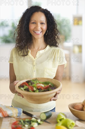 Hispanic woman preparing salad