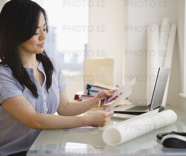 Japanese woman looking at paint swatches