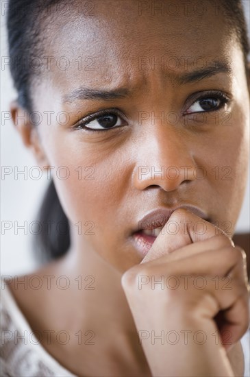 Anxious Black woman frowning