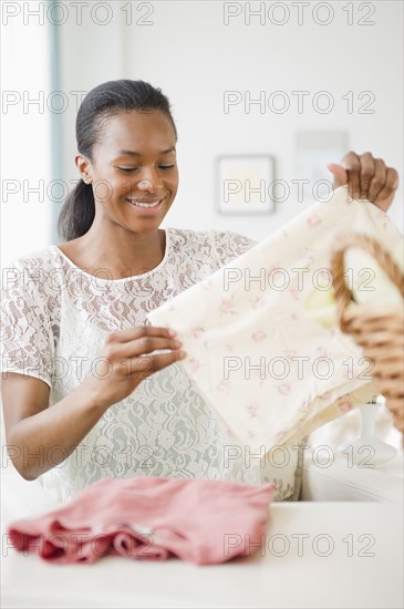 Black woman folding laundry