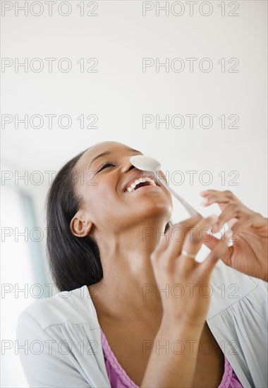 Black woman balancing a spoon on her nose