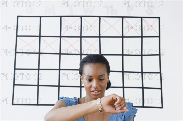 Black woman checking her wristwatch