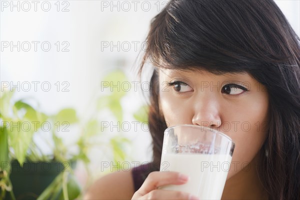 Pacific Islander woman drinking milk