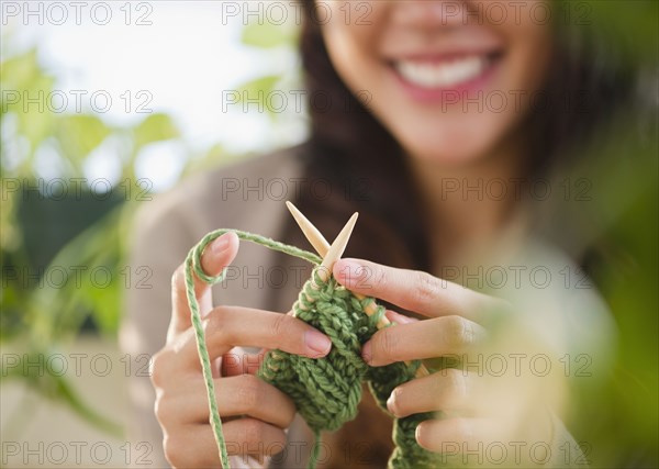 Pacific Islander woman knitting