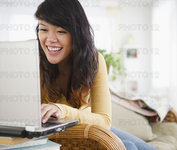 Pacific Islander woman typing on laptop