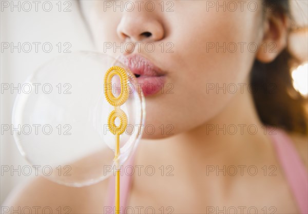 Pacific Islander woman blowing bubble