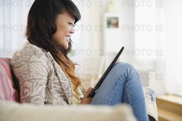 Pacific Islander woman using digital tablet