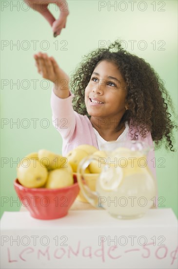 Mixed race girl with lemonade stand
