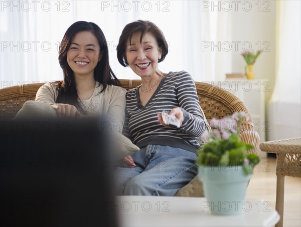 Japanese mother and daughter watching television