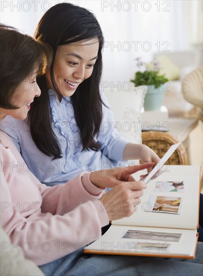 Japanese mother and daughter looking at photo album