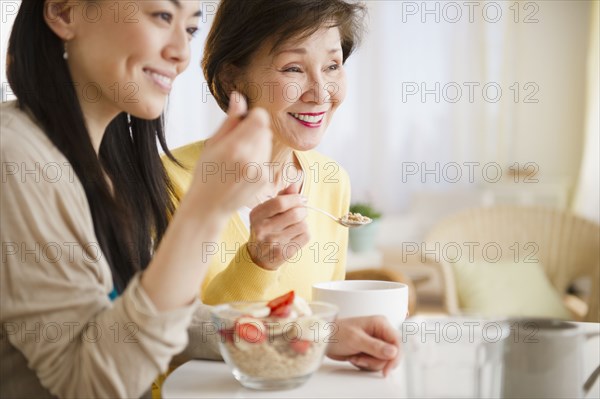 Japanese mother and daughter having breakfast together